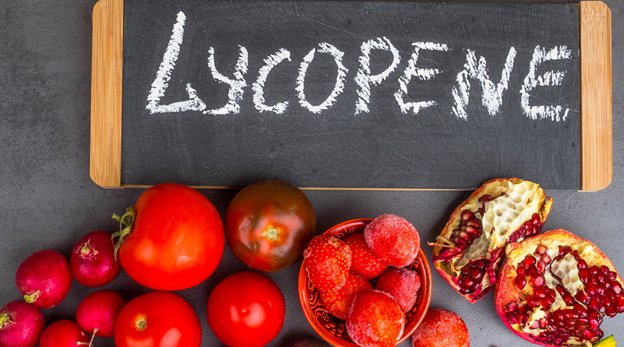 Fresh ripe red tomatoes on the vine, highlighting lycopene carotenoids that protect cardiovascular and vascular tissue.