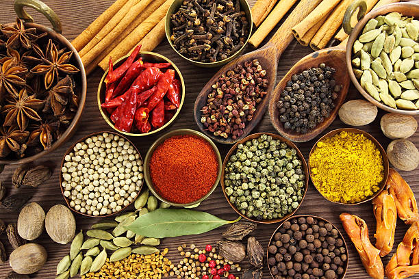A colorful tabletop display of foods that are fermented including glass jars of kimchi, fresh yogurt, and sauerkraut.